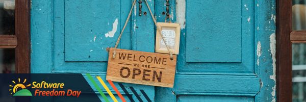 Welcome sign at a door: "Welcome, we're open"